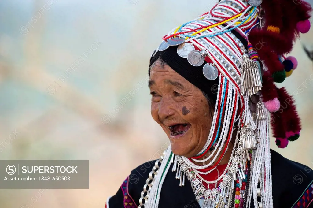 Smiling woman with headdress of the Akha hill tribe, ethnic minority, Northern Thailand, Thailand, Asia