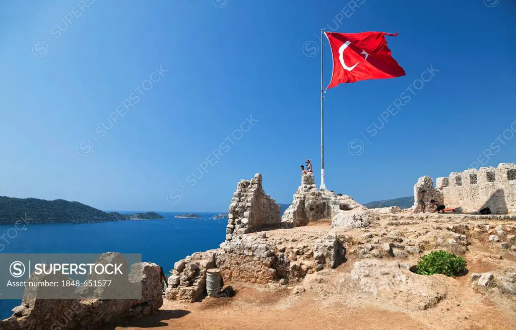 Byzantine castle of Kalekoey with a Turkish national flag, ancient city of Simena, Lycian coast, Lycia, Mediterranean Sea, Turkey, Asia Minor