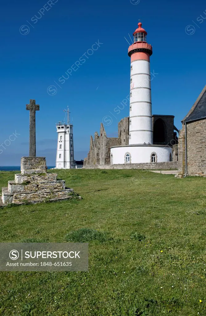 Monastery ruins, lighthouse from 1865 and modern naval control tower, stone cross on a lawn at front, Cape Point de Saint Mathieu, Département Finistè...