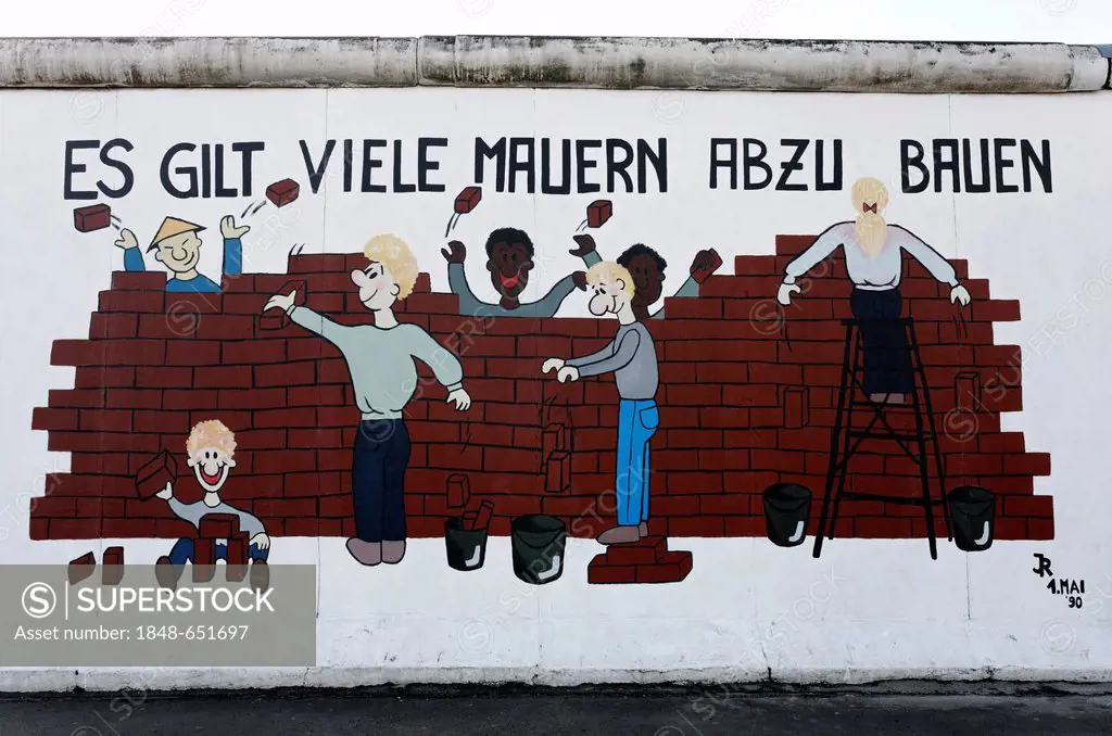 Chinese, blacks, whites, men and woman tearing down a wall together, painting on the remants of the Berlin Wall, East Side Gallery, Friedrichshain dis...