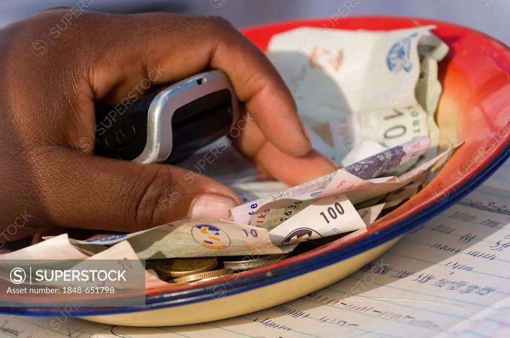 Hand and banknotes, Rand or ZAR, the currency of South Africa, sacrificial offerings, Sangoma or Witchdoctor Festival, Wild Coast or Transkei, South A...