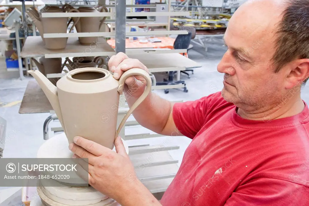 Employees attaching a handle, coffee pot from Hutschenreuther, in the production of tableware at the porcelain manufacturer Rosenthal GmbH, Speichersd...