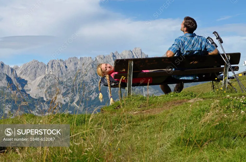 Hiker taking a break on Mt Hartkaiser with views of Wilder Kaiser massif, Tyrol, Austria, Europe