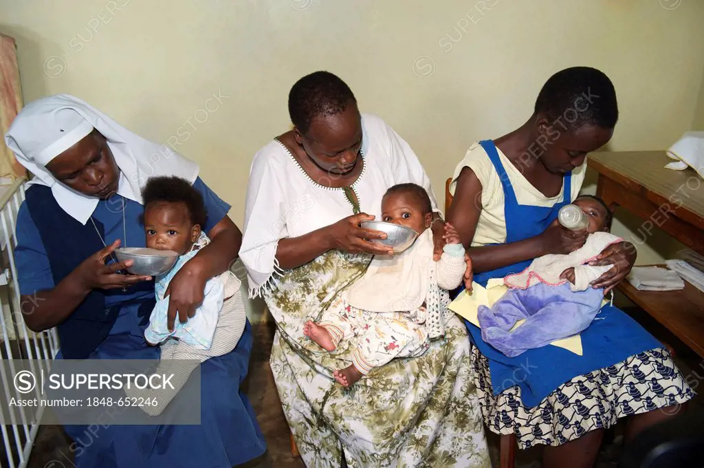 Infants being fed by children's nurses in an orphanage near Bukoba, Tanzania, Africa