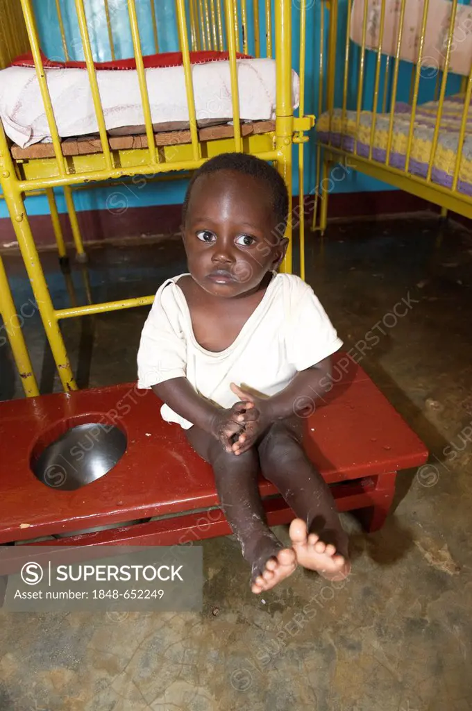 Small child on the potty in an orphanage near Bukoba, Tanzania, Africa