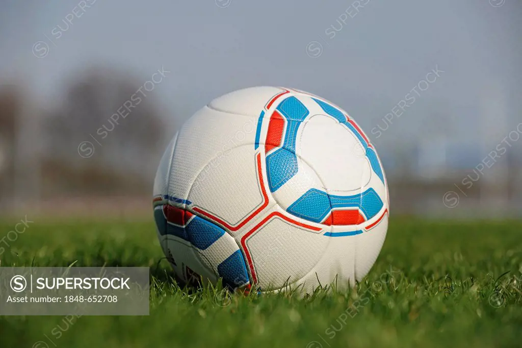 Official soccer ball of the German Bundesliga, football lying on a grass field