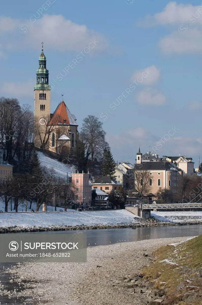 View from the banks of the Salzach River towards Muelln, Muellner Church on the edge of Moenchberg mountain, Salzburg, UNESCO World Heritage Site, Aus...