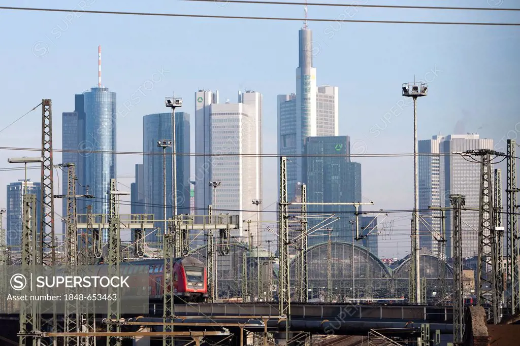 Frankfurt main station with a moving train of the German Federal Railways, Frankfurt skyline at the back, Commerzbank tower, Deutsche Bank tower, Hess...