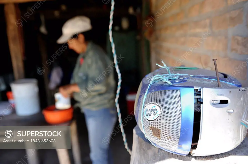 Smallholder is listening to the radio in the kitchen in the remote Chaco region, made possible by solar cells on the roof, Gran Chaco, Santiago del Es...