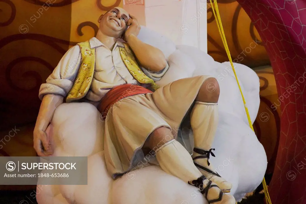 Man wearing a skirt, sitting on a cloud and dreaming, crude carnival character, satirical sculpture at a parade, Fallas festival, Falles festival in V...