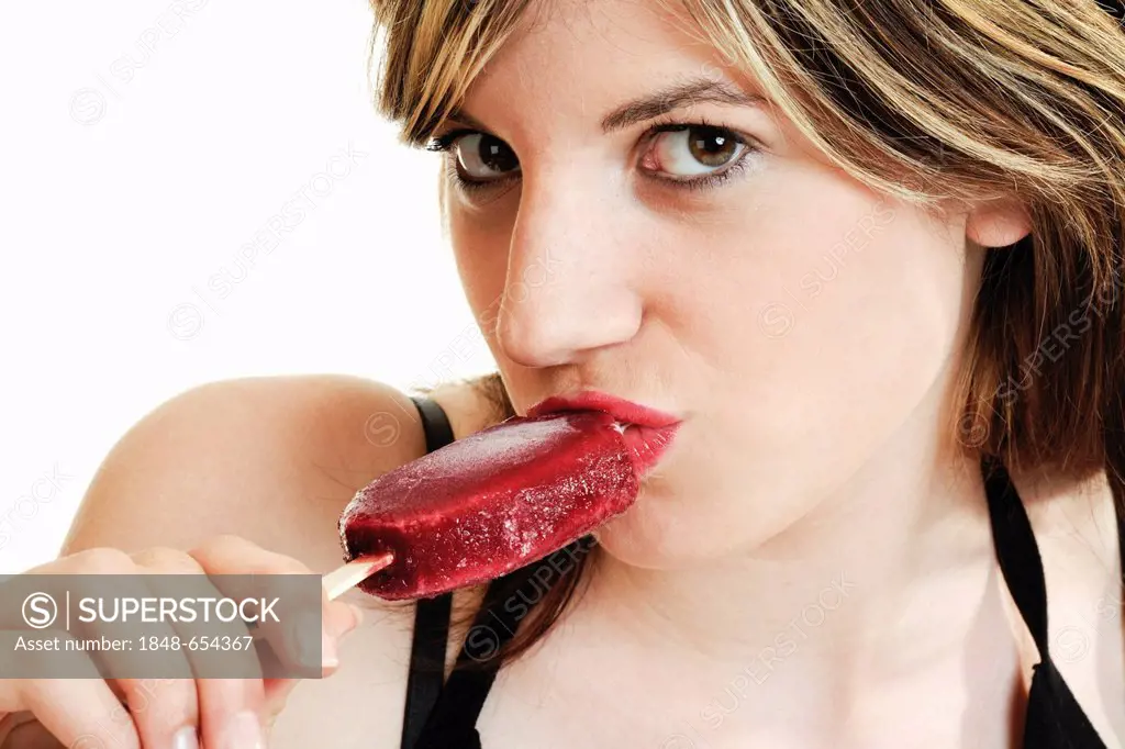 Young woman sucking an ice cream on a stick