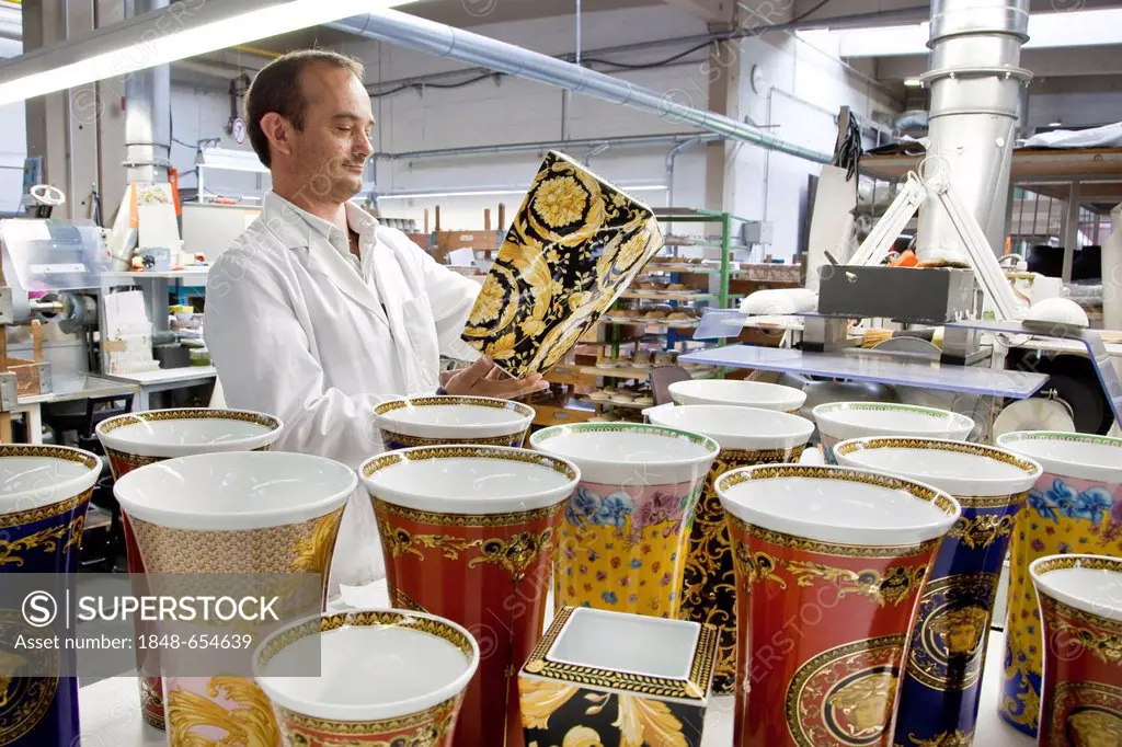 Final inspection of a Versace vase after polishing the gold at the porcelain manufacturer Rosenthal GmbH, Speichersdorf, Bavaria, Germany, Europe
