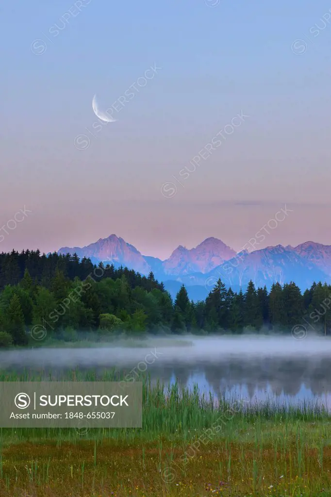 Lake Hegratsrieder with the moon, composing, near Fuessen, Allgaeu, Bavaria, Germany, Europe