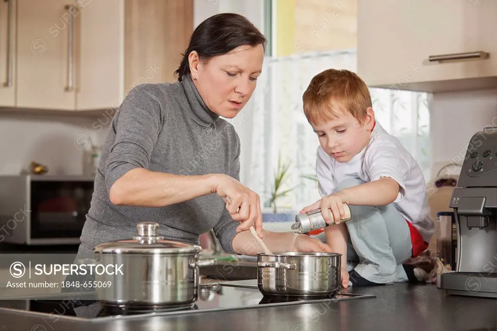 Mother and son cooking