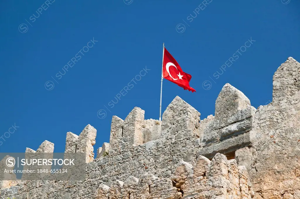 Byzantine castle of Kalekoey with a Turkish national flag, battlements, ancient city of Simena, Lycian coast, Lycia, Mediterranean Sea, Turkey, Asia M...