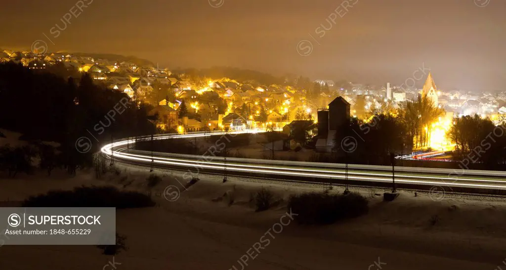 Light trace of a train in winter at night, Beimerstetten, Baden-Wuerttemberg, Germany, Europe