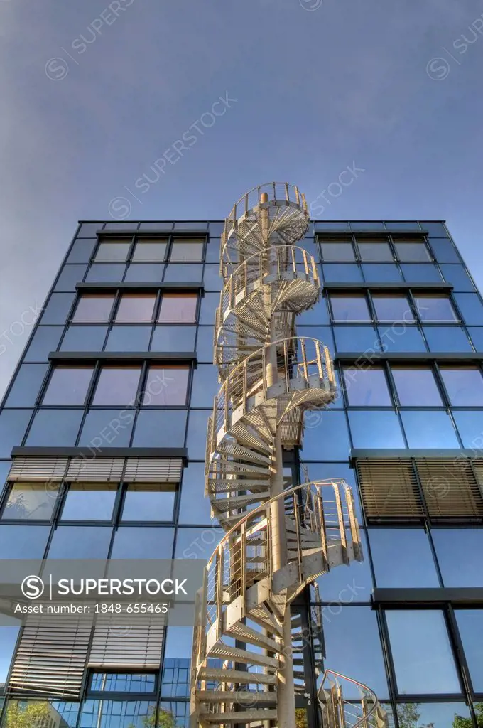 Modern office architecture with spiral staircase, glass office building, metal external staircase, blue sky, near Munich, Upper Bavaria, Bavaria, Germ...