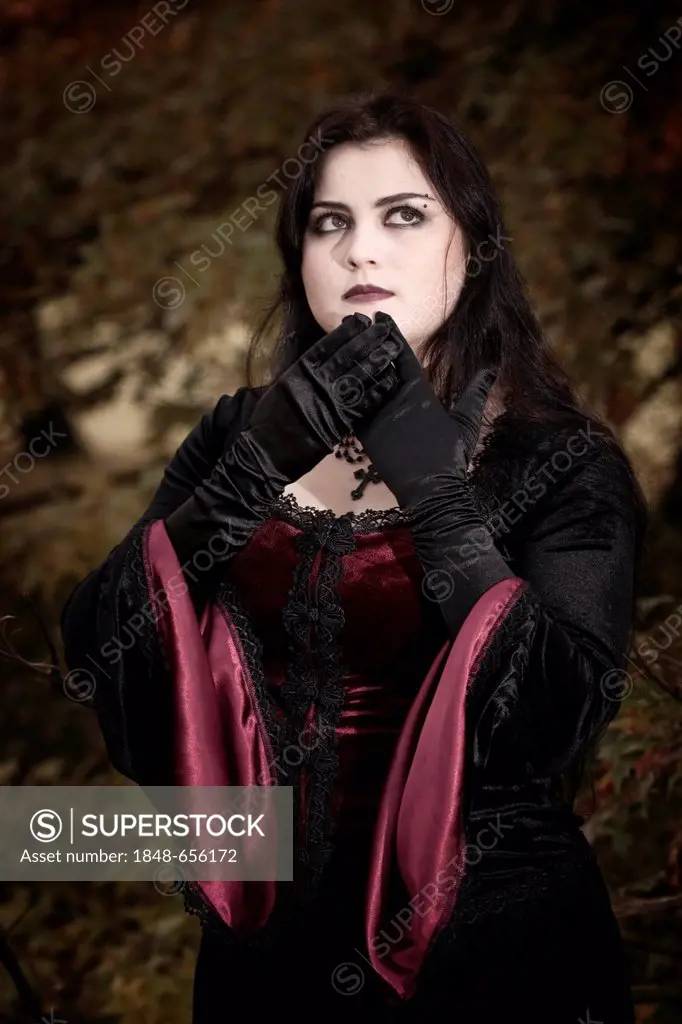 Woman, dressed in a Gothic style, Romantic-Gothic, standing, looking serious