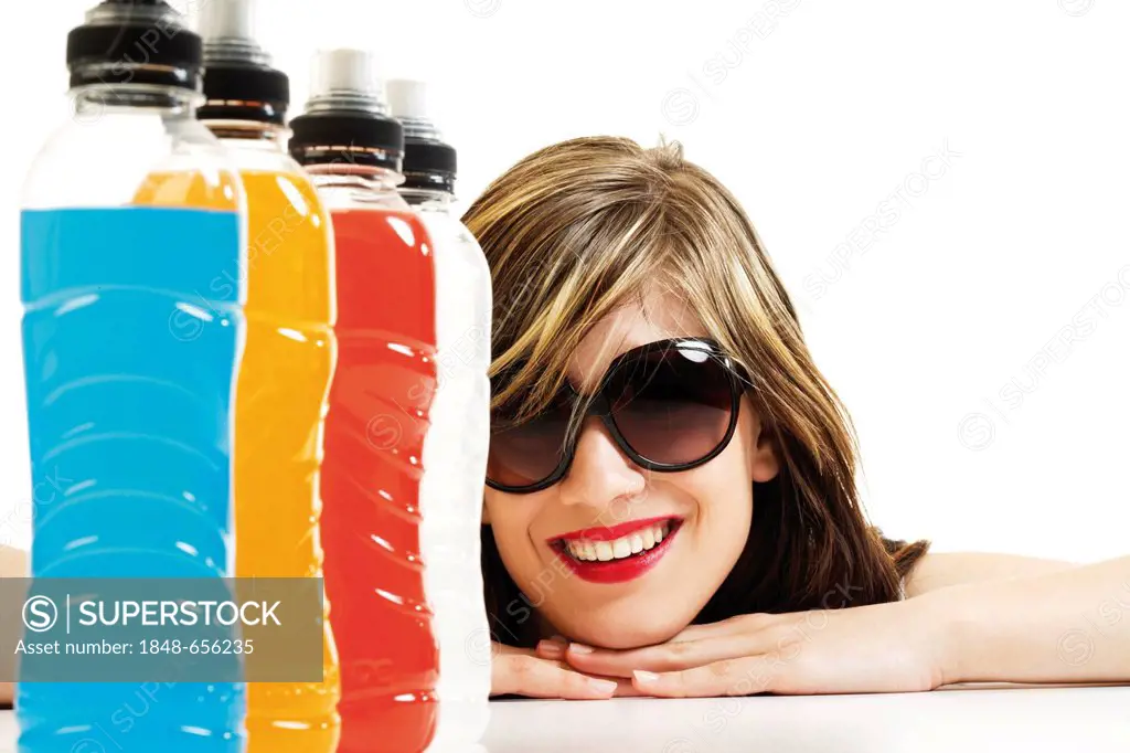 Young woman behind a row of power drink bottles