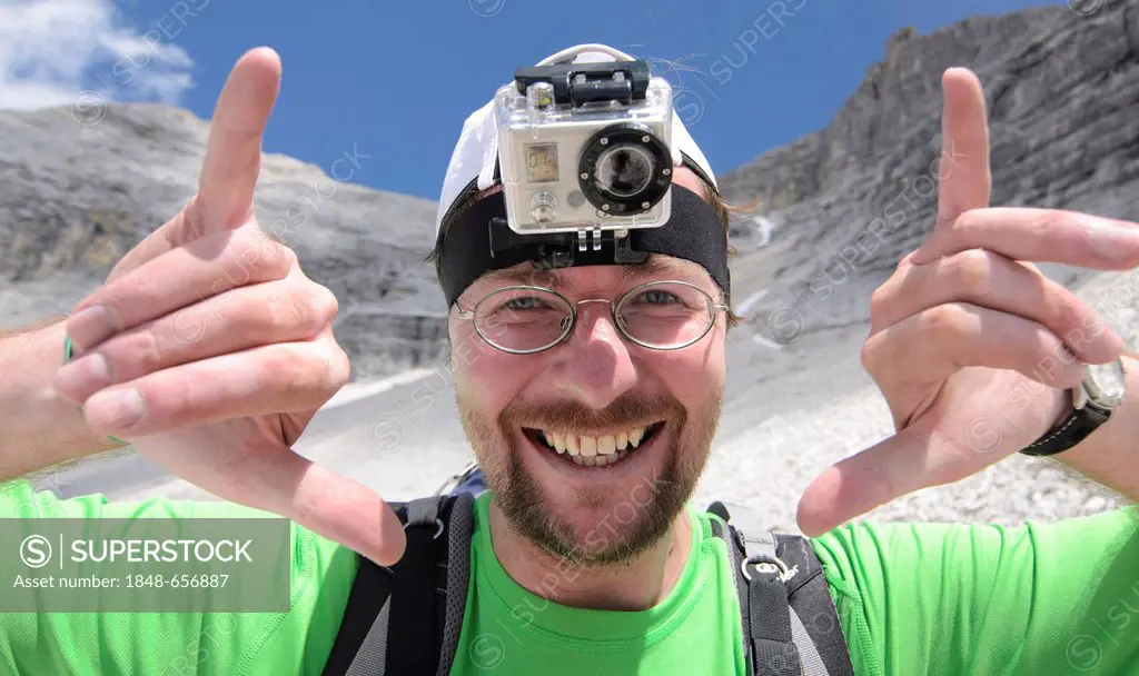 Young man, mountain hiker with a GoPro HD Video Camera mounted to his head, Karwendel Mountains National Park, Tyrol, Austria, Europe