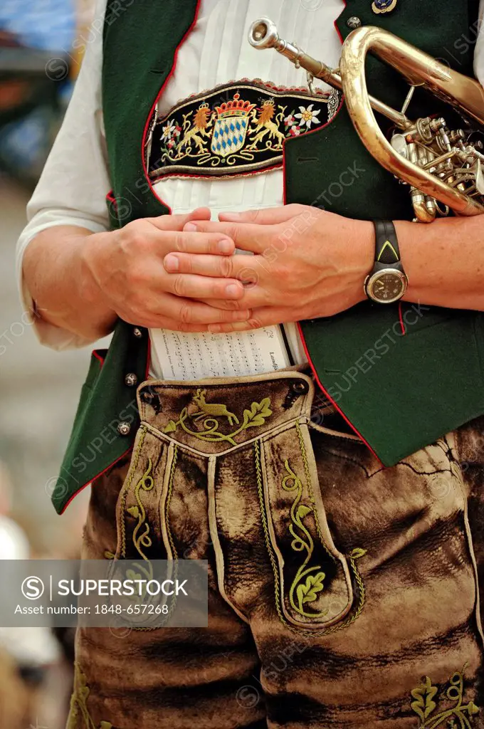 Musician of a Bavarian brass band wearing a traditional Bavarian costume with leather pants or lederhosen, altes Festzelt beer tent, Oktoberfest festi...