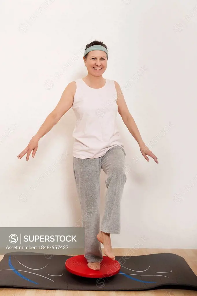 Woman standing on a balance ball