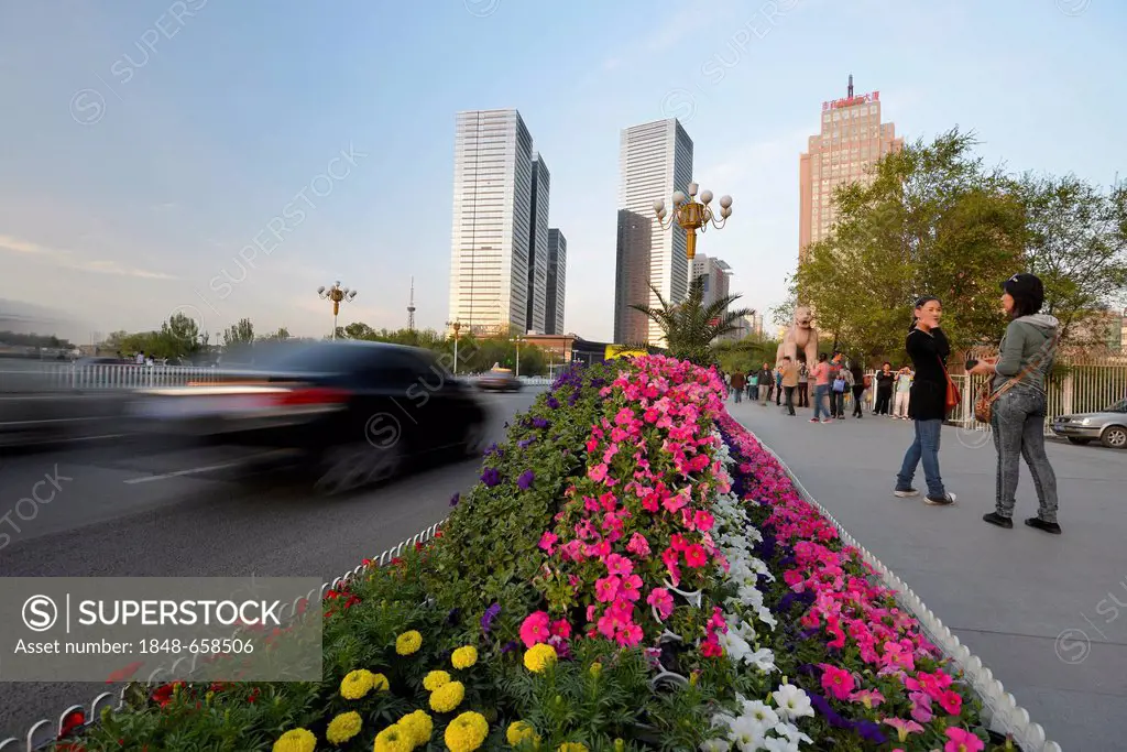 Flower beds on a highway, new skyline of Ueruemqi at the back, Silk Road, Xinjiang, China, Asia