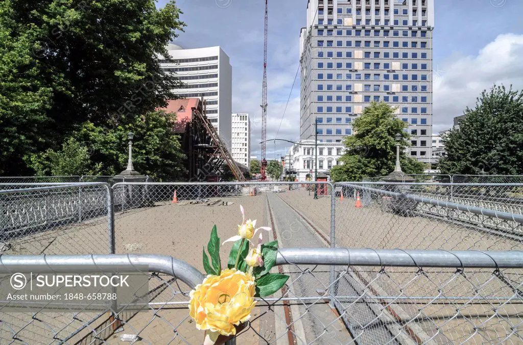 Flowers on a fence, cordoned off town centre in the earthquake zone of Christchurch, South Island, New Zealand