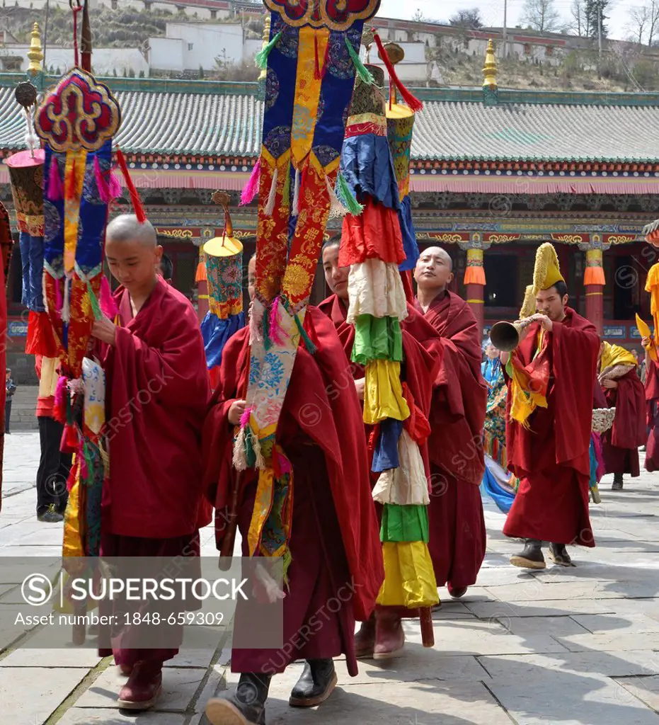 Tibetan Buddhism, procession of the Tibetan monks and novices after the Cham dance, religious masked dance in the great Gelugpa monastery of Kumbum, T...