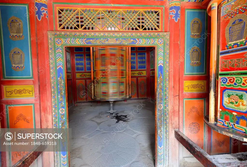 Tibetan Buddhism, wooden prayer wheel painted with Buddhist symbols, cylinder, at the kora, Labrang Monastery, Xiahe, Gansu, formerly Amdo, Tibet, Chi...