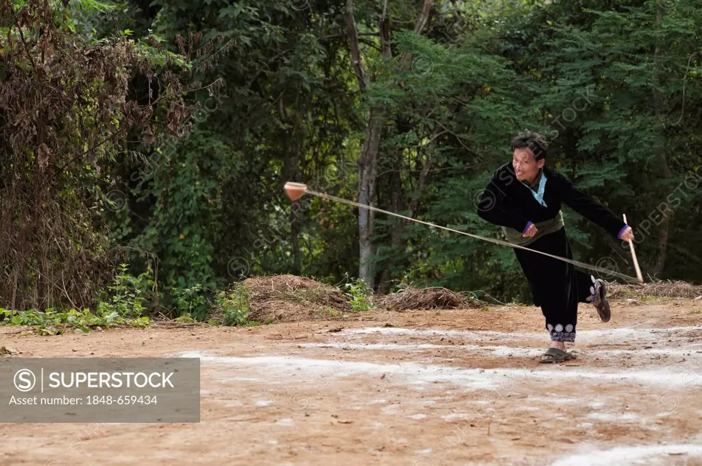 Traditional spinning top, Tujlub, competition action at a Hmong new year festival at Hung Saew village, Chiang Mai, Thailand, Asia
