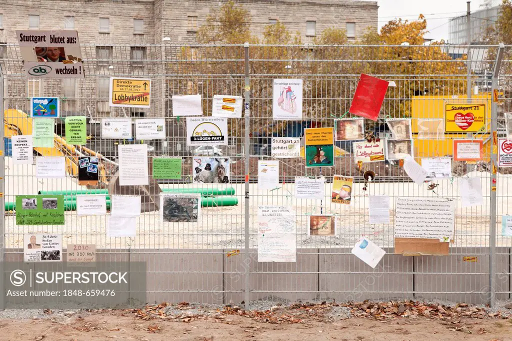 Protest posters against Stuttgart 21 railway project on a site fence at Stuttgart's main station, Schlossgarten, castle gardens, Stuttgart, Baden-Wuer...
