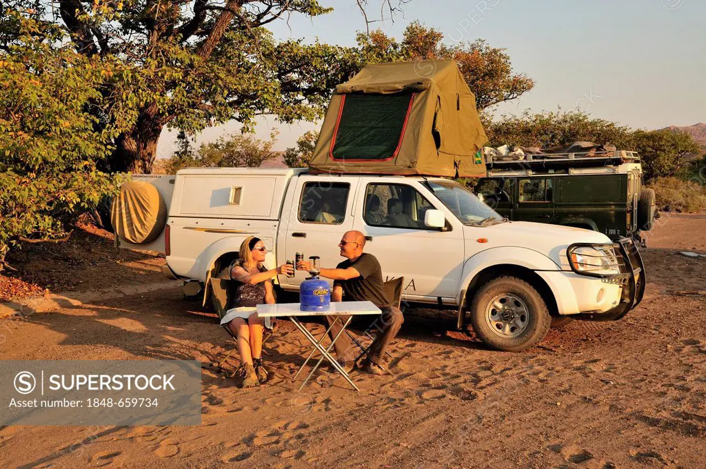 Tourists in front of their camping vehicle in Twyfelfontein, Damaraland, Namibia, Africa