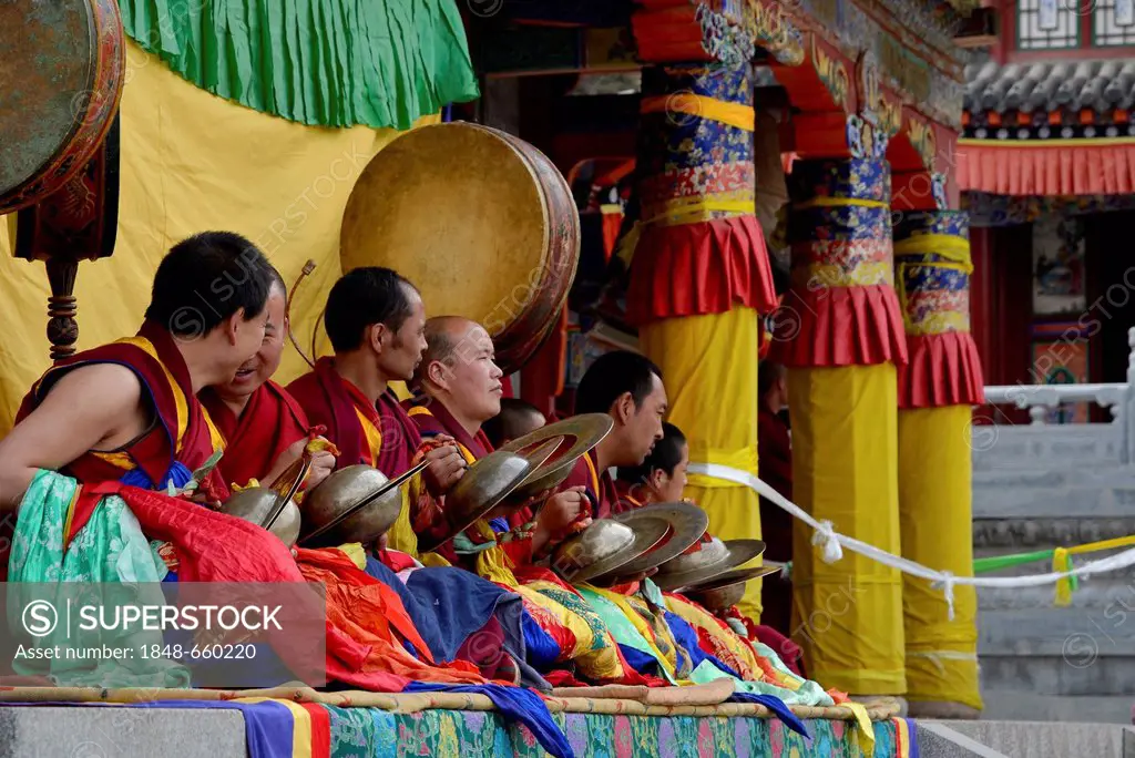 Tibetan Buddhism, monk orchestra, monks with instruments at the religious masked dance Cham festival in the important Gelupgpa monastery of Kumbum, Ta...