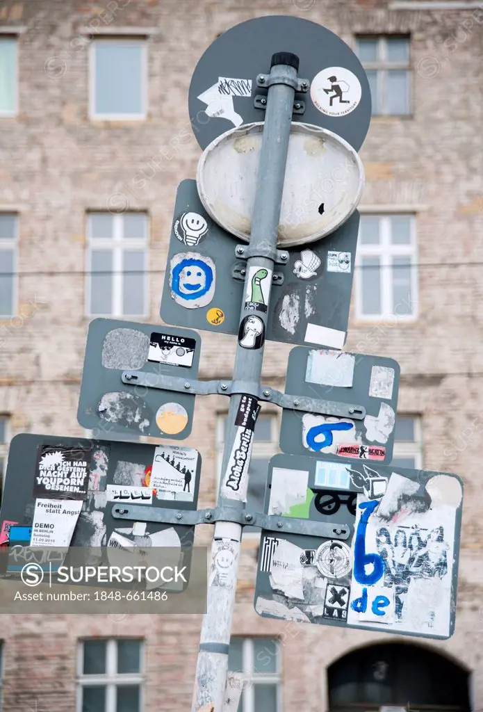 Road signs seen from behind with stickers in front of the facade of a building on Oranienburgerstrasse, Berlin, Germany, Europe
