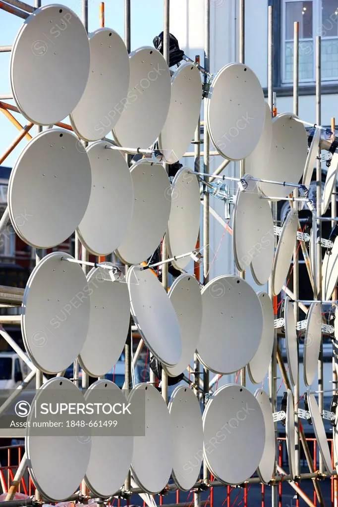 Many TV satellite dishes on a frame
