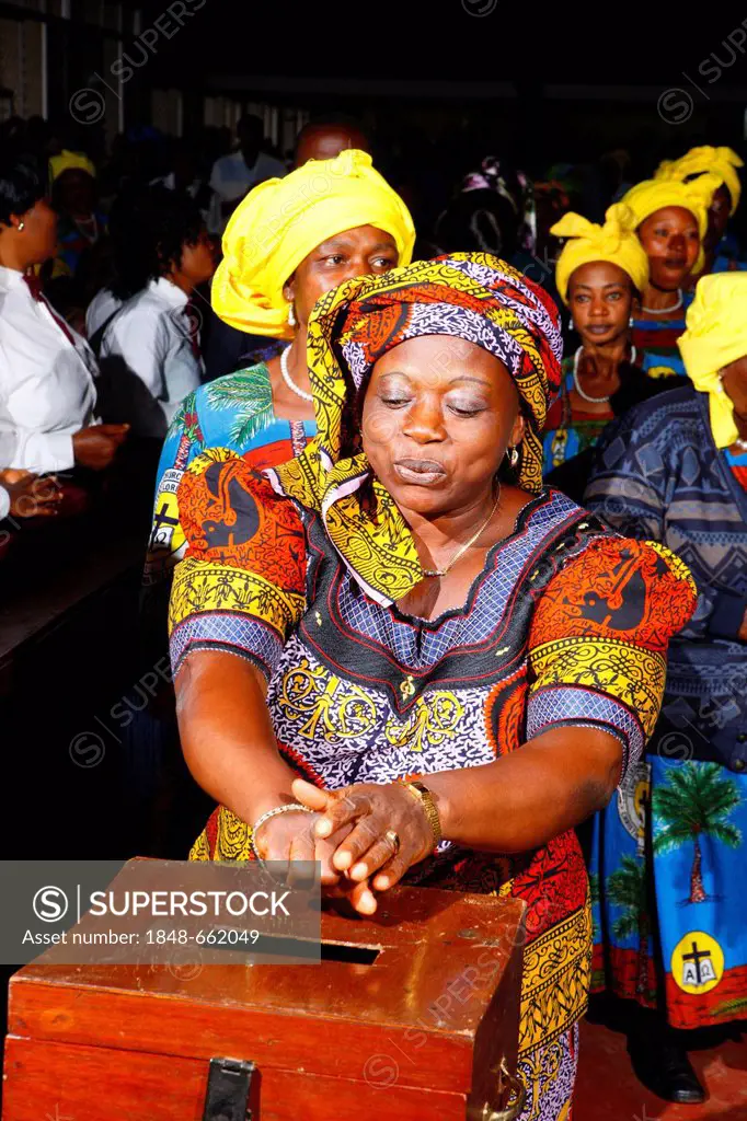 Woman donating money at a Sunday church service, Bamenda, Cameroon, Africa