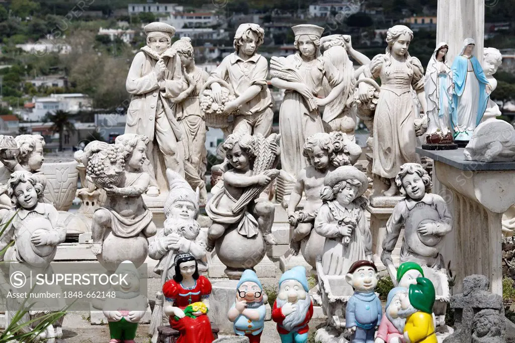Concrete figures in an open-air exhibition, colourful mixture of putti, garden gnomes and statues of the Virgin Mary, Ischia Island, Gulf of Naples, C...