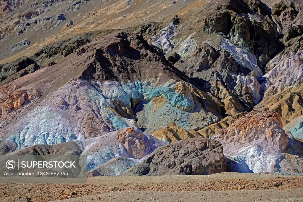 Stones coloured by minerals at the Artists Palette in the evening light, Death Valley National Park, California, USA