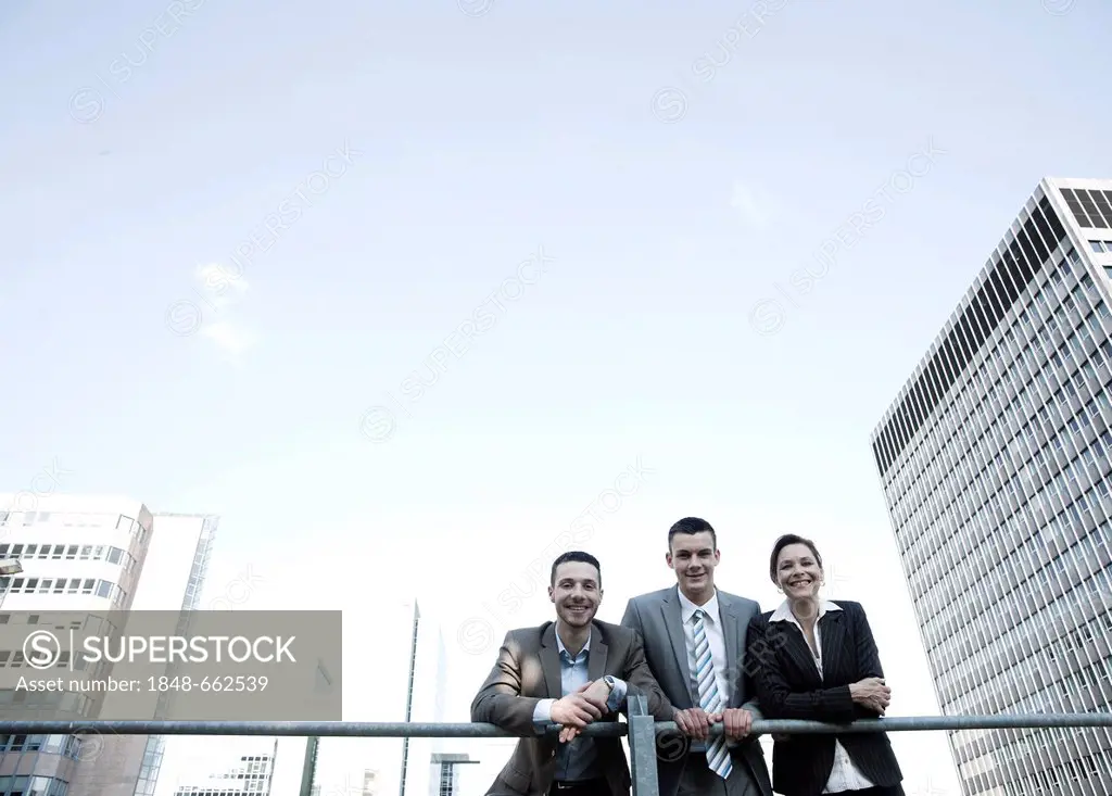 Group of business people in front of tall buildings