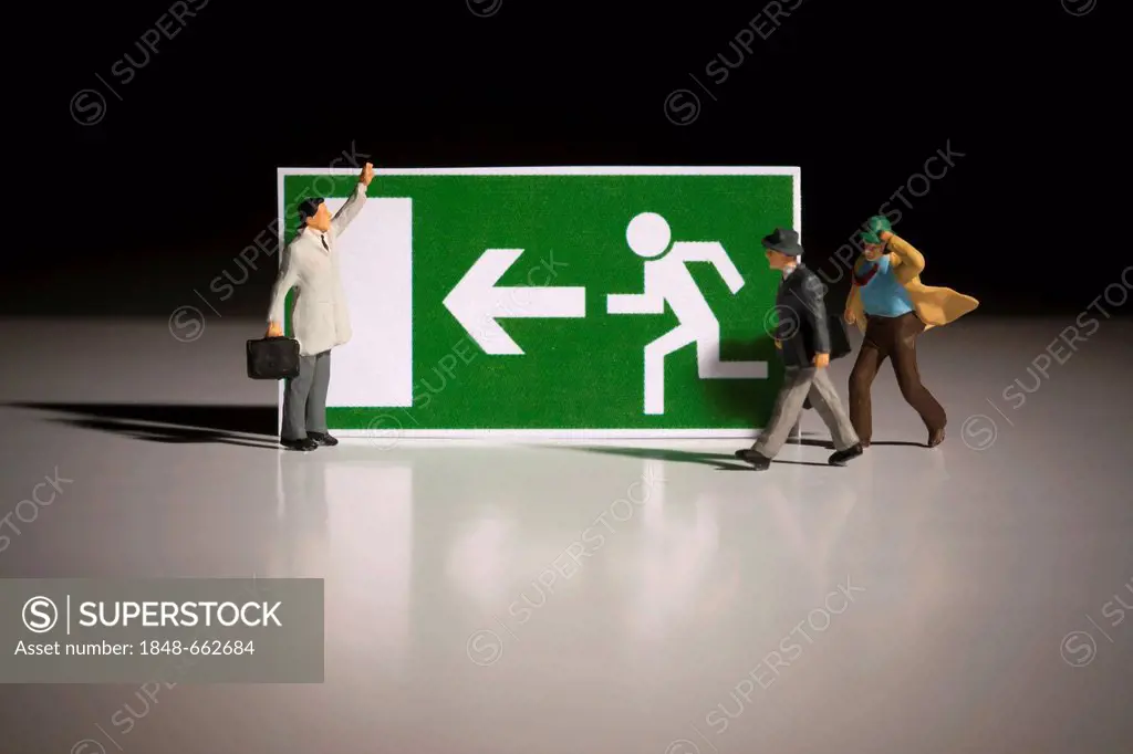 Emergency exit direction sign with miniature business people figures, symbolic image recovery in the financial crisis, economic crisis, way out in tim...
