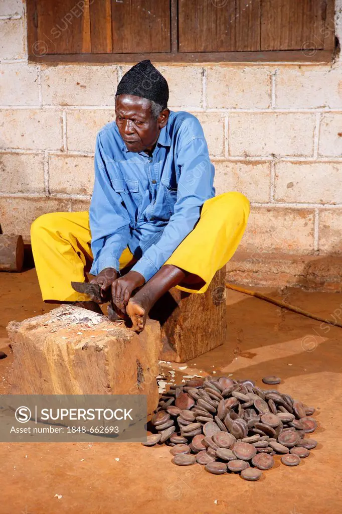 Man producing traditional foot and hand rattles, Juju Rattles from Uyot, Bafut, Cameroon, Africa