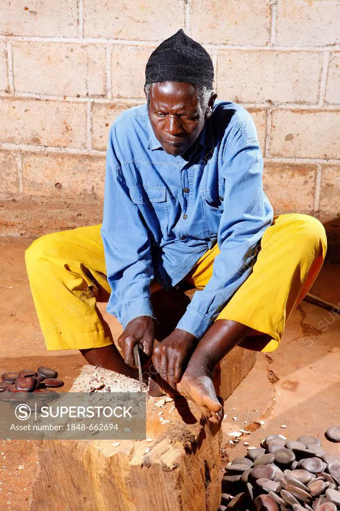 Man producing traditional foot and hand rattles, Juju Rattles from Uyot, Bafut, Cameroon, Africa