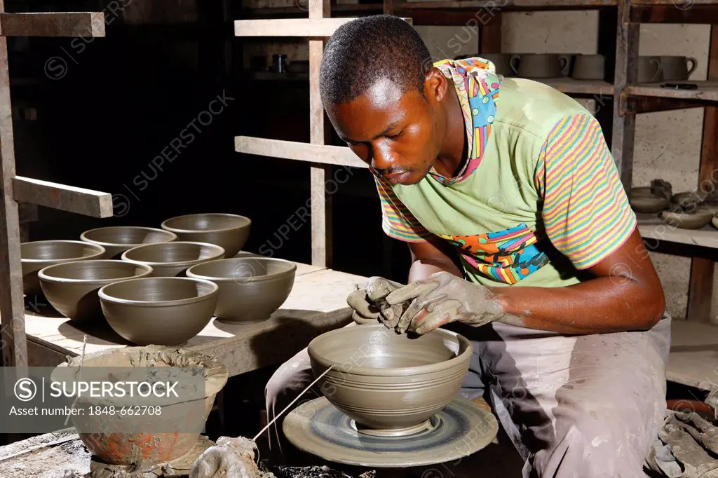 Man working at a potter's wheel producing pottery, Bamessing, Cameroon, Africa