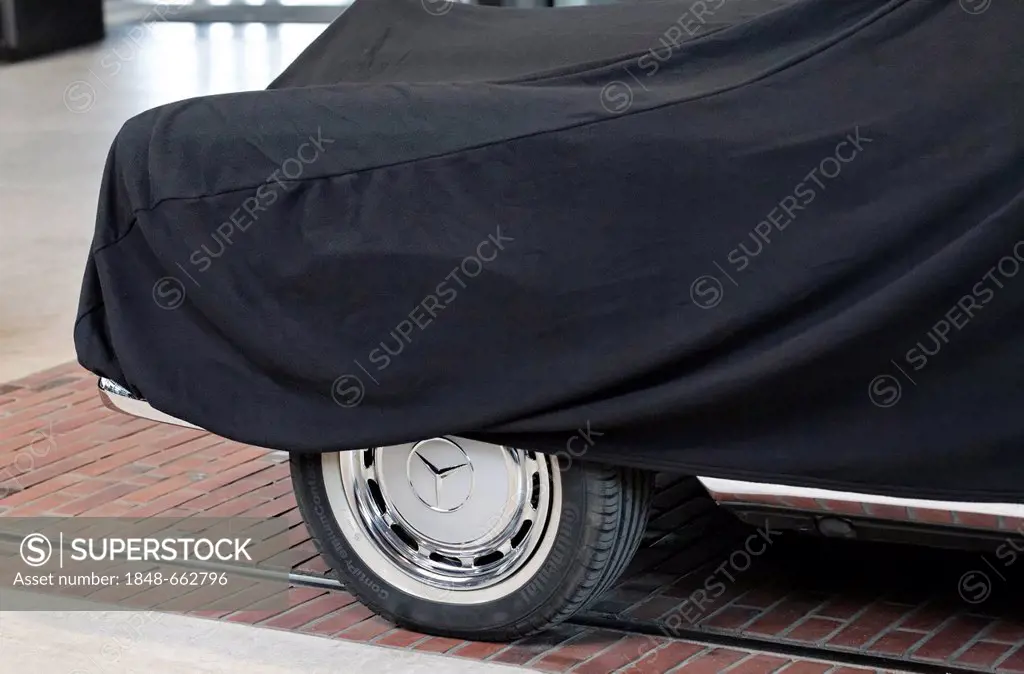 Mercedes vintage car covered with a black cloth with one wheel visible, Meilenwerk Duesseldorf, Duesseldorf, North Rhine-Westphalia, Germany, Europe