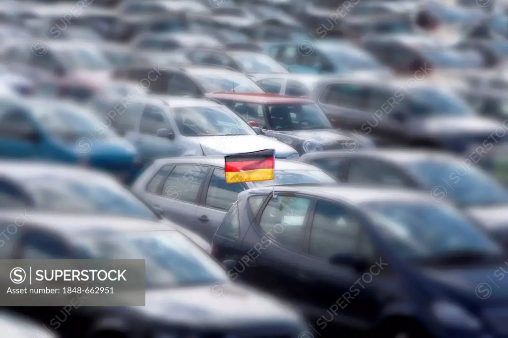 Car with a German national flag, occupied parking area, concept image for the lack of parking spaces in Germany
