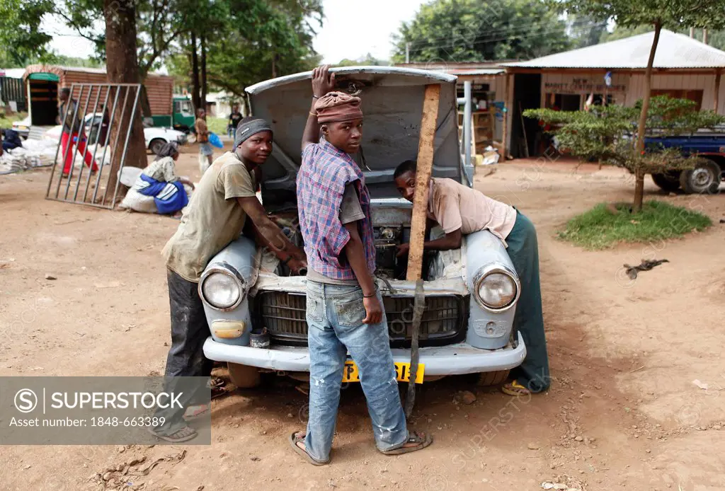 Men repairing a car in Marangu village, Kilimanjaro National Park, Tanzania, East Africa, Africa
