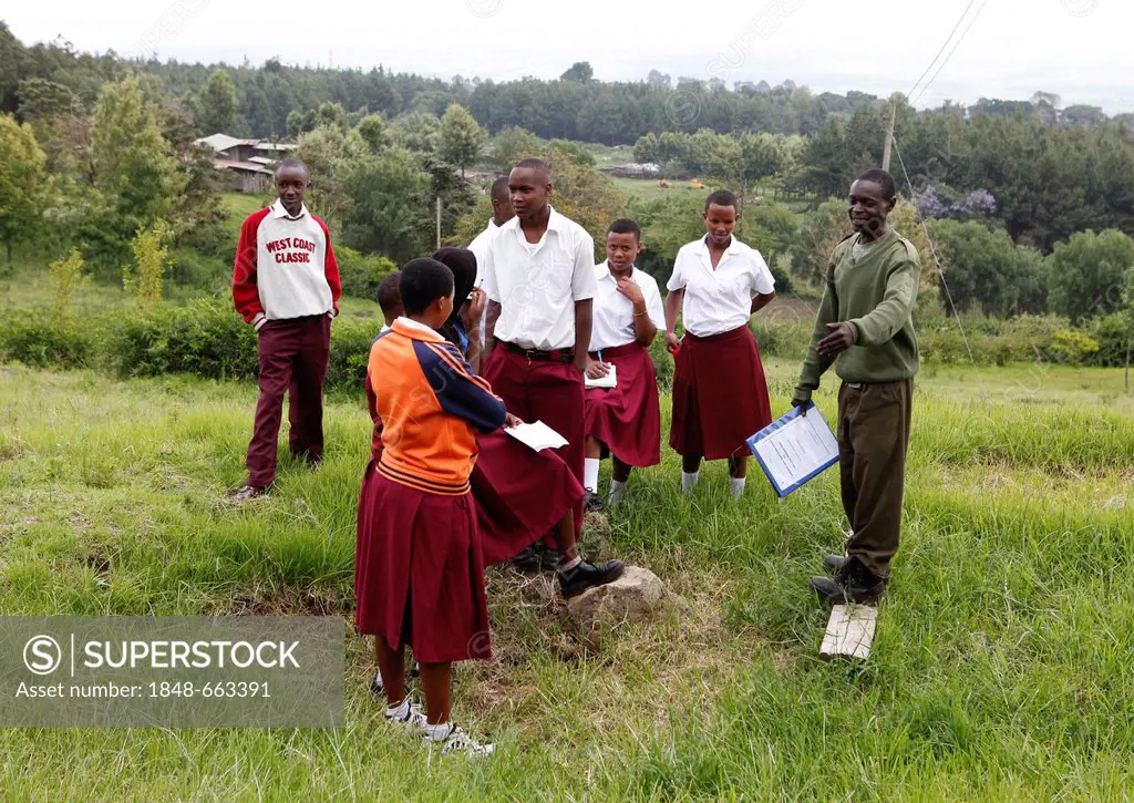 Member of the Kilimanjaro National Park team explaining the Kilimanjaro Climb to students, Marangu Route to Mt. Kilimanjaro, Kilimanjaro National Park...