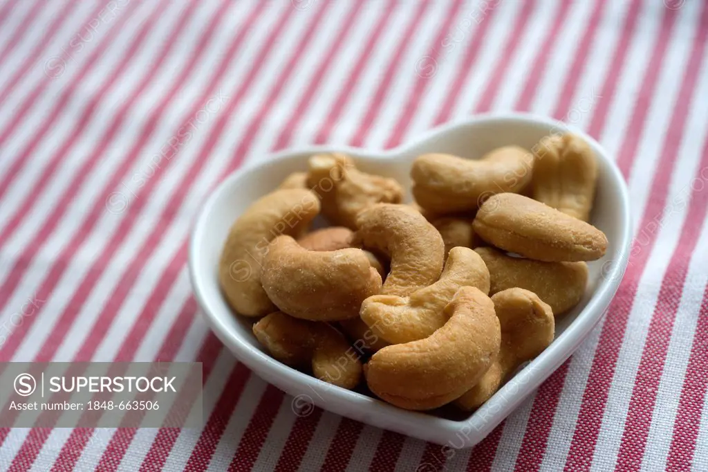 Roasted cashews in a heart-shaped bowl