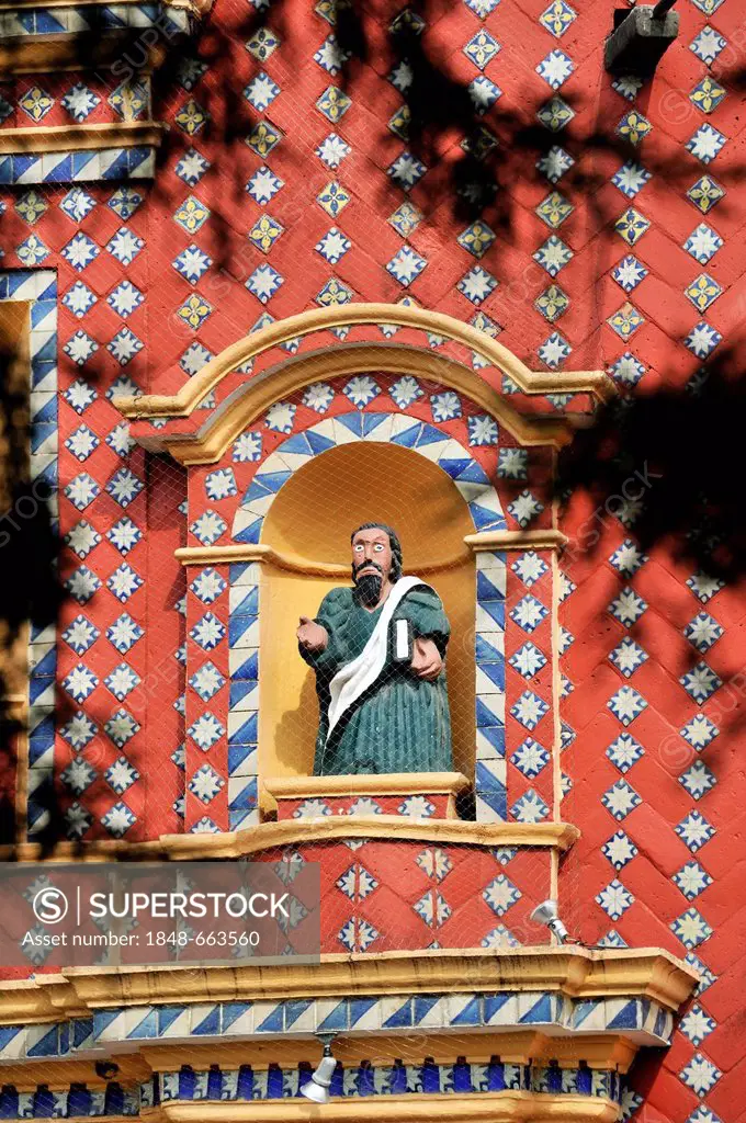 Statue of an evangelist with indigenous features in the facade of the church of Iglesia Santa Maria de Tonantzintla, San Pedro Cholula, Puebla, Mexico...